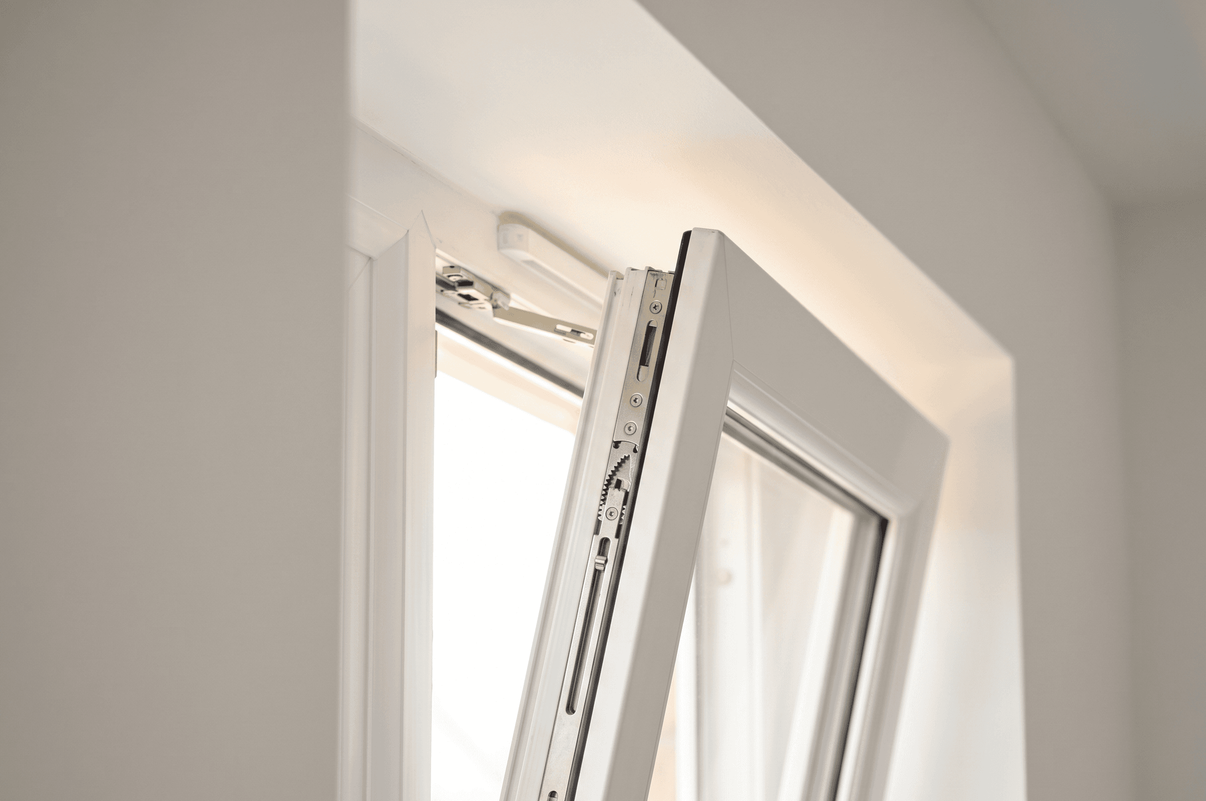 Tilt and turn UPVC window open inside a bright room